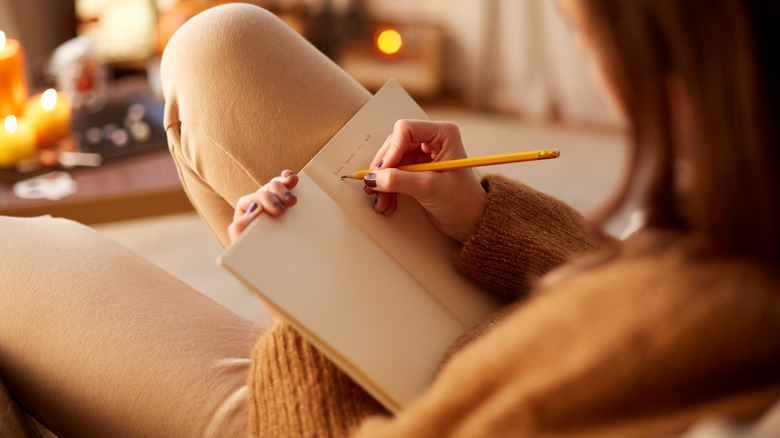 Woman writing in a journal