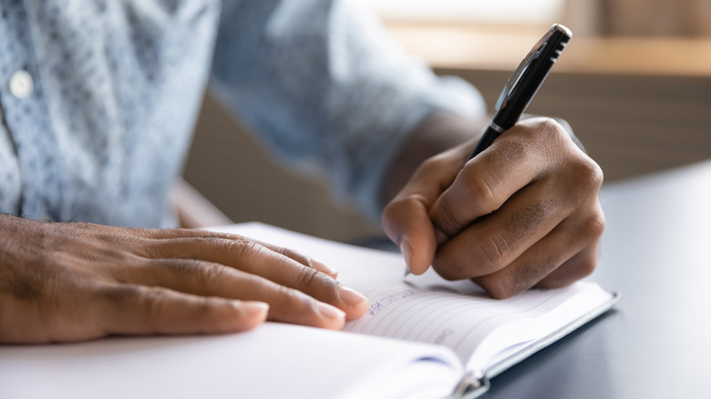 Man writing in notebook