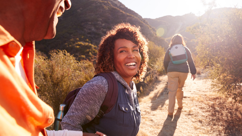 woman happy and smiling on the hiking trail