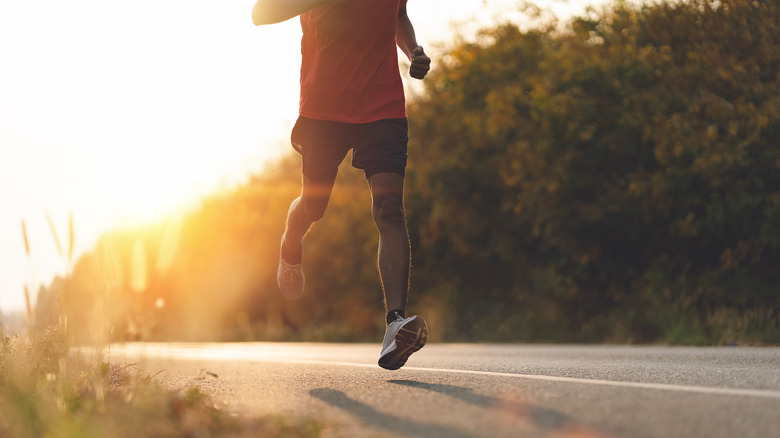 person running on road at dusk