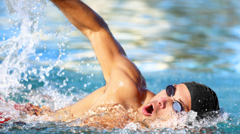 man swimming outdoors