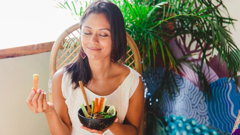 smiling woman eating hummus