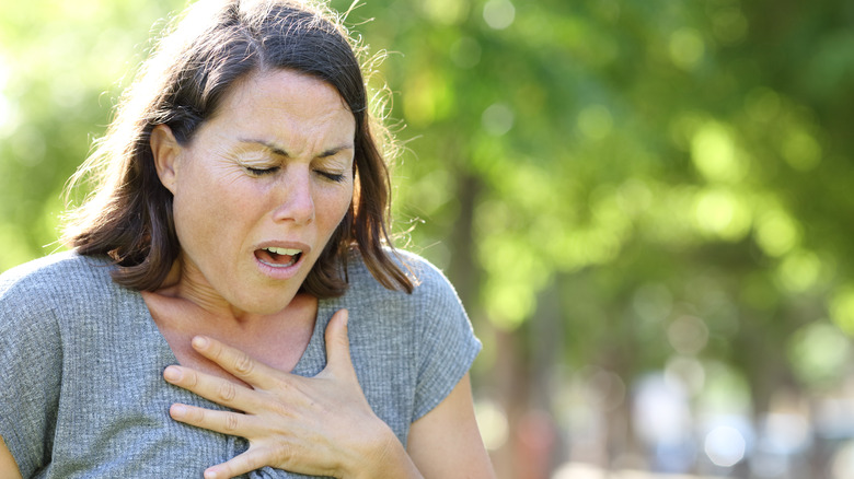 woman holding chest