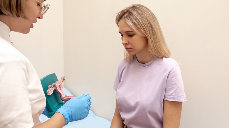 A doctor talks to a patient about the uterus