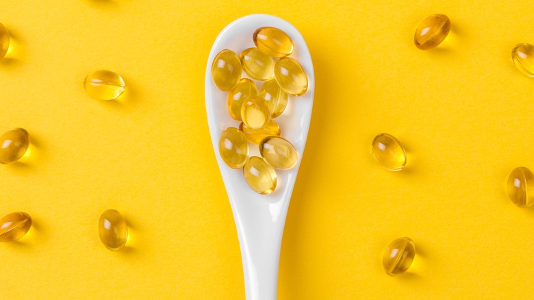 vitamin e capsules on spoon