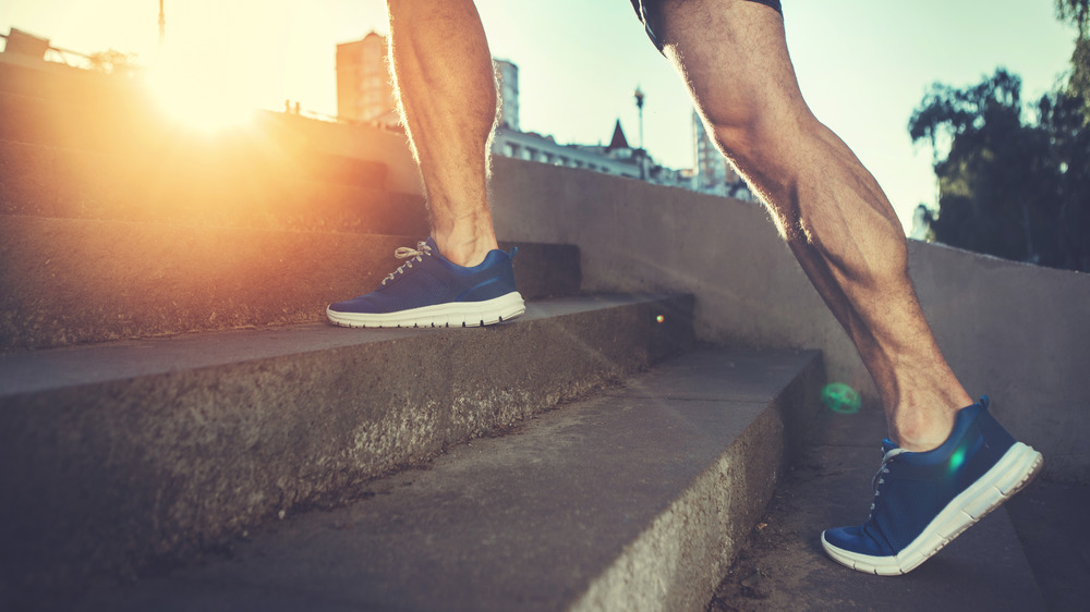 Closeup of a man's feet climbing stairs outside