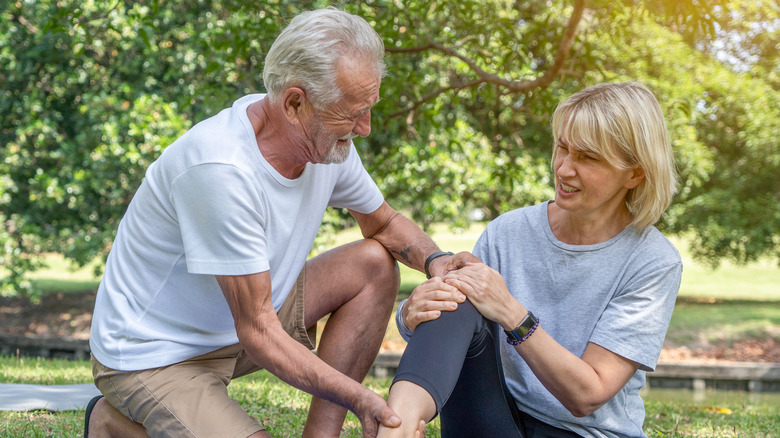 Man helping woman who is in pain