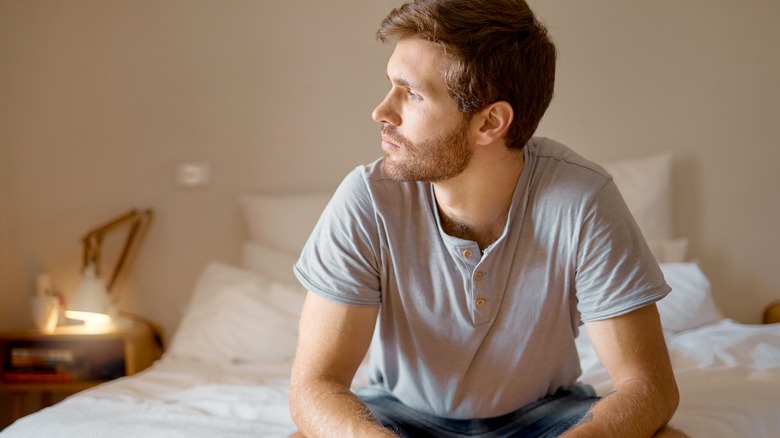 man sitting on bed