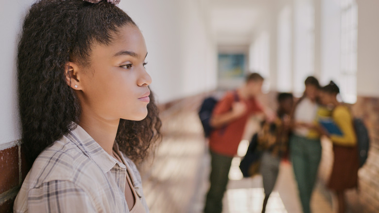 girl standing against wall