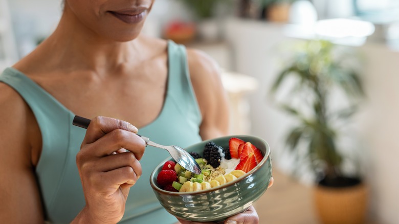 woman eating out of bowl