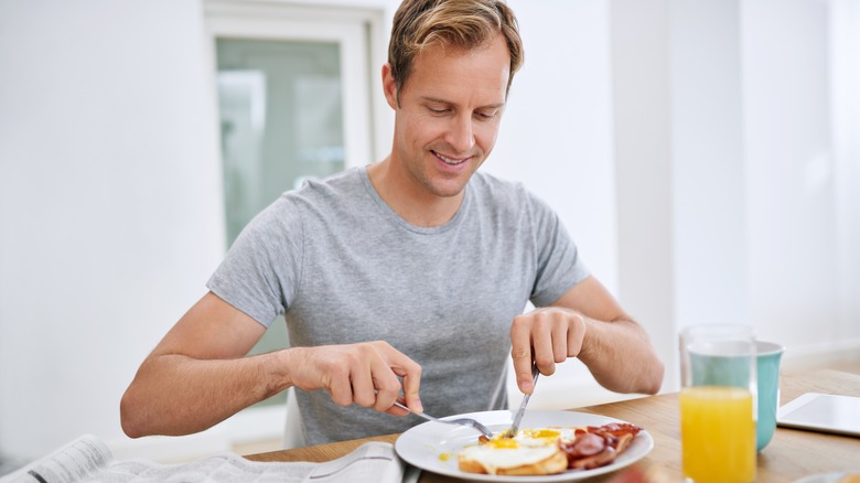 man eating eggs for breakfast