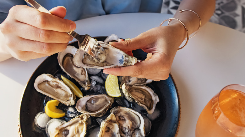 Woman eating oysters