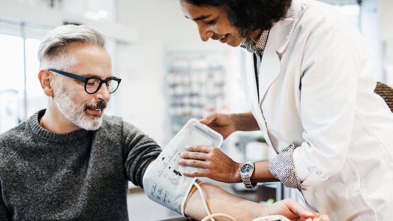 man getting blood pressure taken by provider