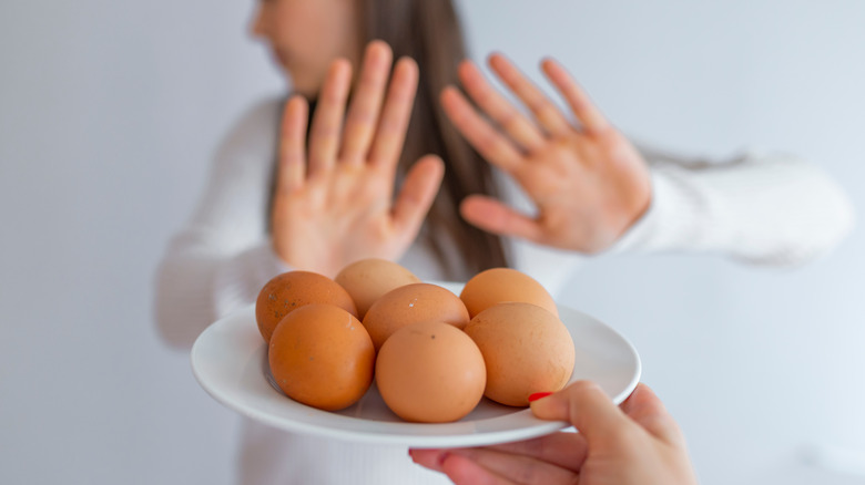 Young girl refusing raw eggs