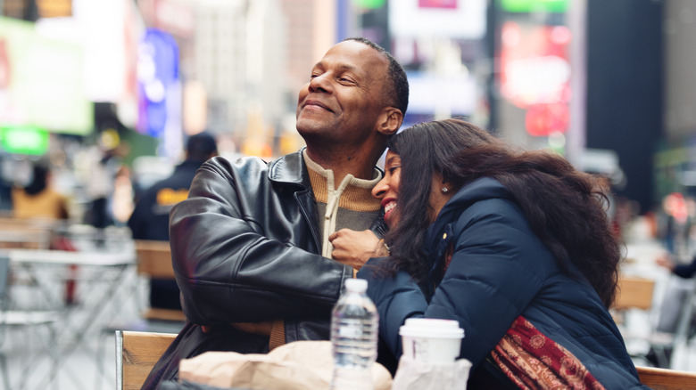 A man and woman dining in time's square