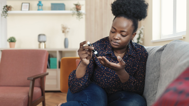 woman checking her blood sugar at home