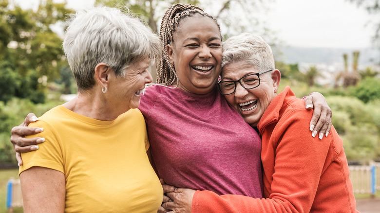 Three people hugging