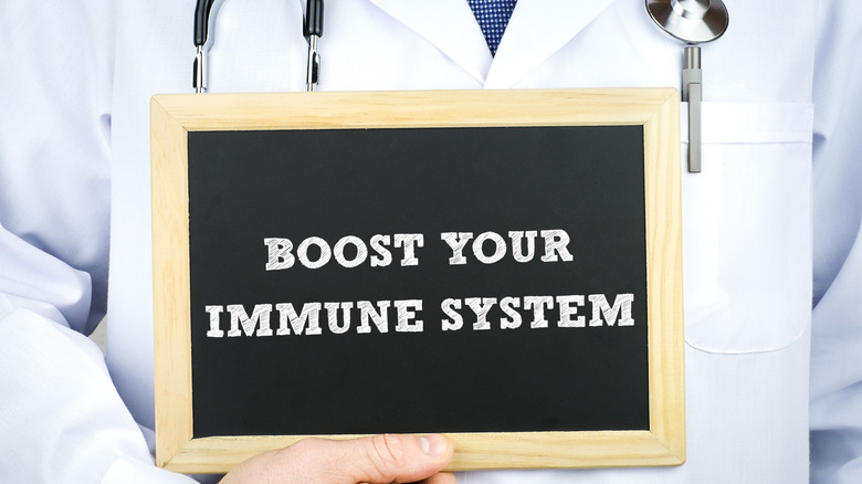 doctor holding 'boost your immune system' sign