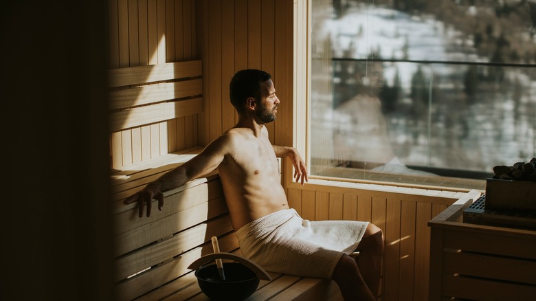 a man sitting in the sauna 