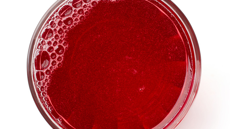 A closeup of cranberry juice in a glass