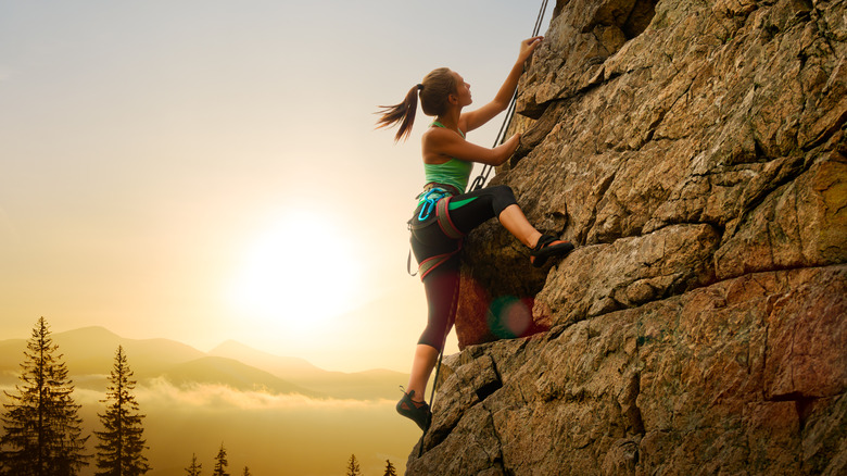 rock climbing girl at sunset