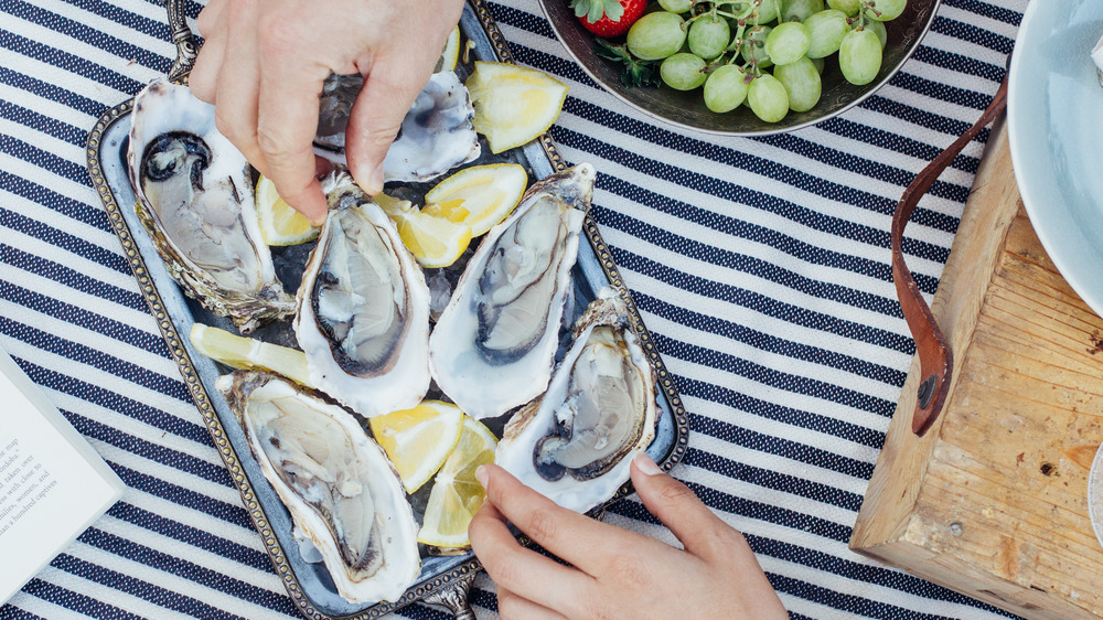 man and woman's hand, oysters