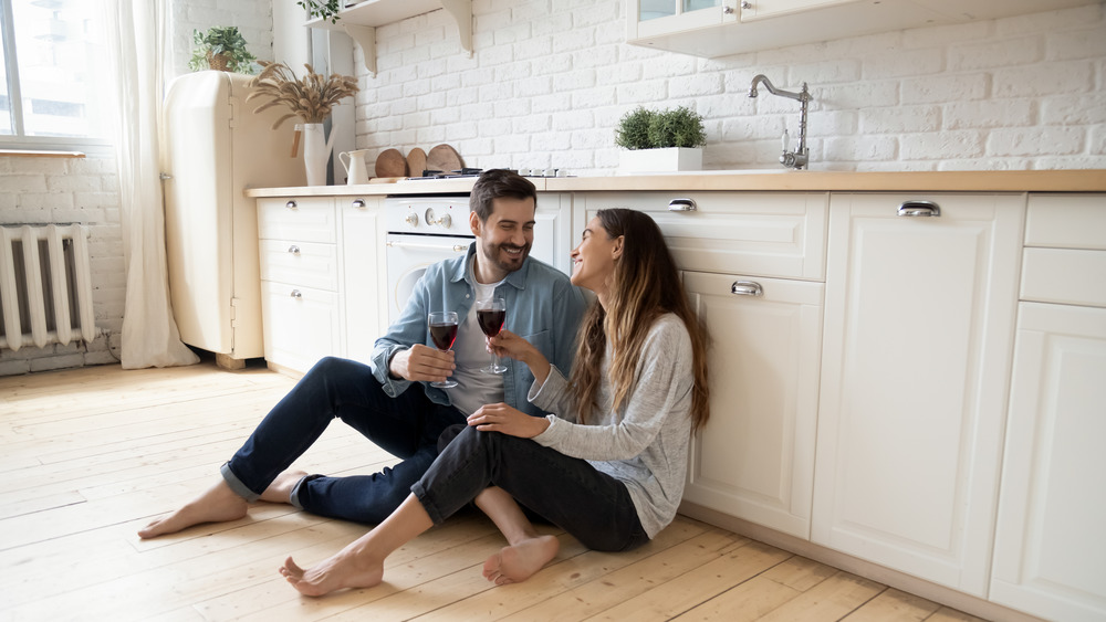 couple drinking wine in kitchen