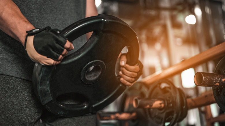 man holding weight plate