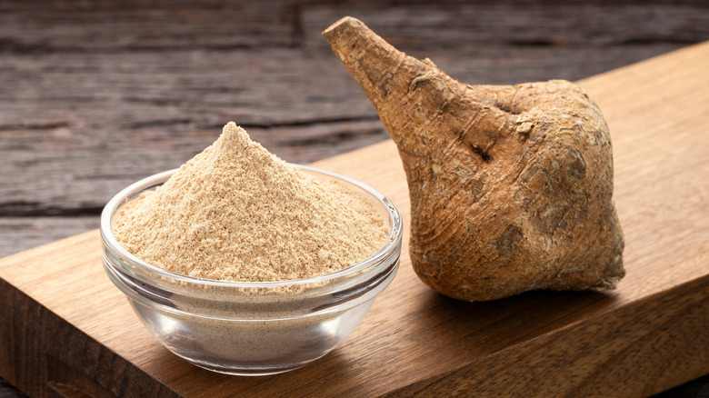 Maca root and maca powder sitting on a table