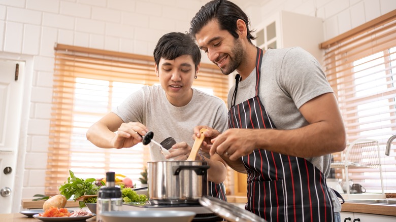 Happy couple cooking stew