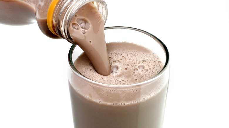 Pouring glass of chocolate milk