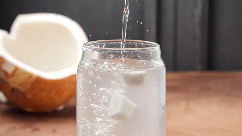 Coconut water being poured into a glass