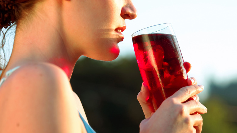 Woman drinking cranberry juice after workout