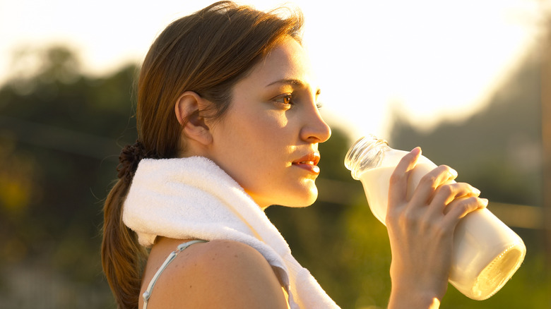 woman drinking milk after a workout