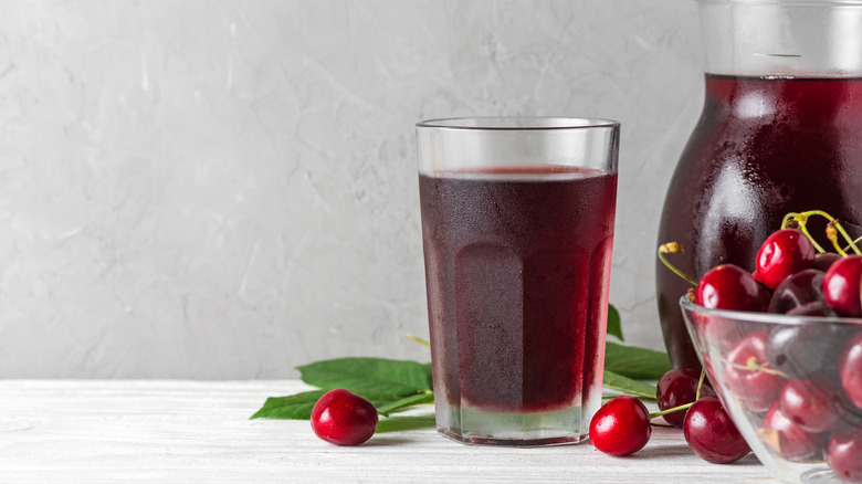 Pitcher and glass of tart cherry juice with cherries