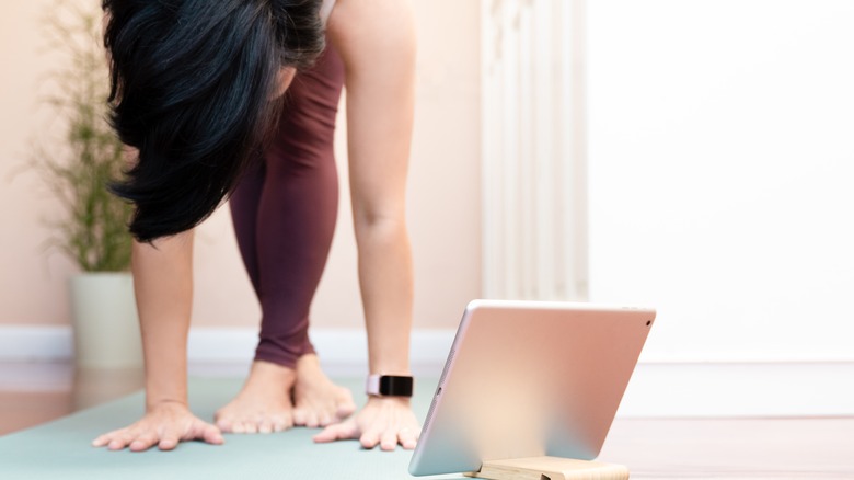 Standing forward bend with crossed legs