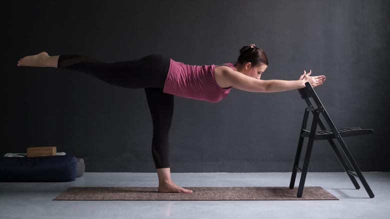 Warrior III yoga pose with chair