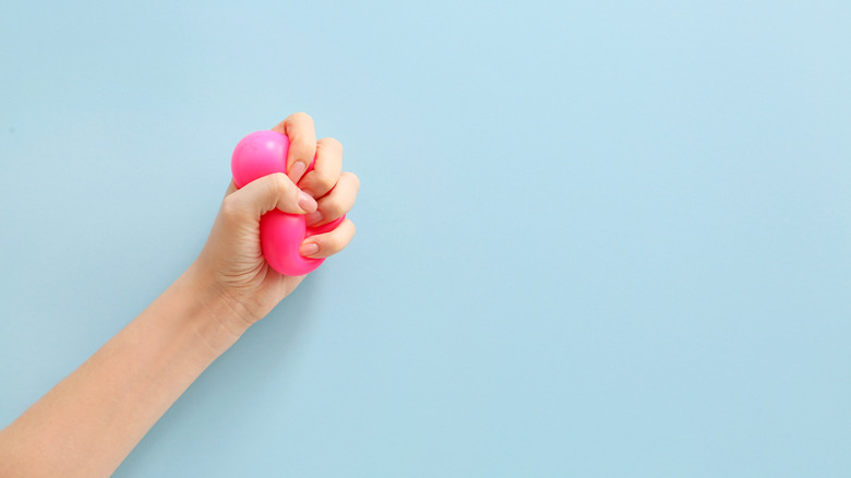 person squeezing stress ball