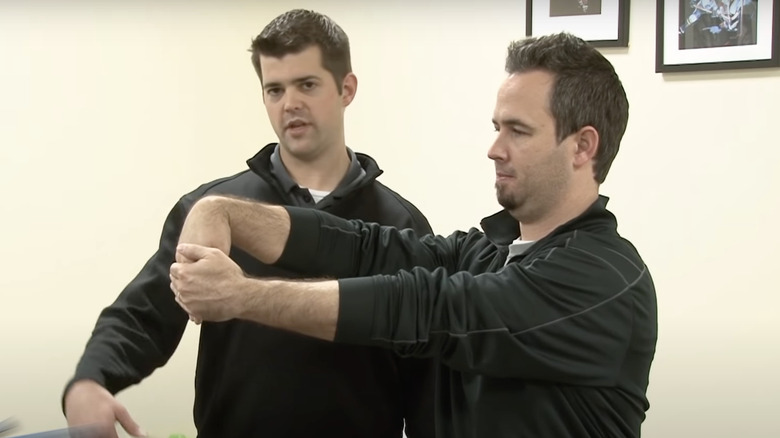 man doing wrist flexion stretch