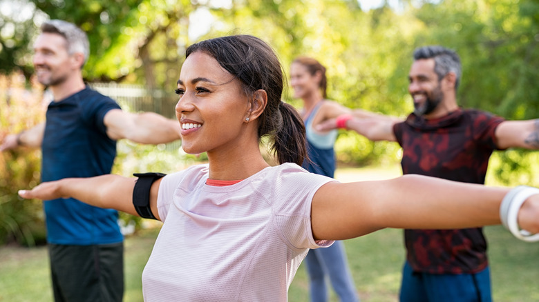 People doing arm circles to stretch