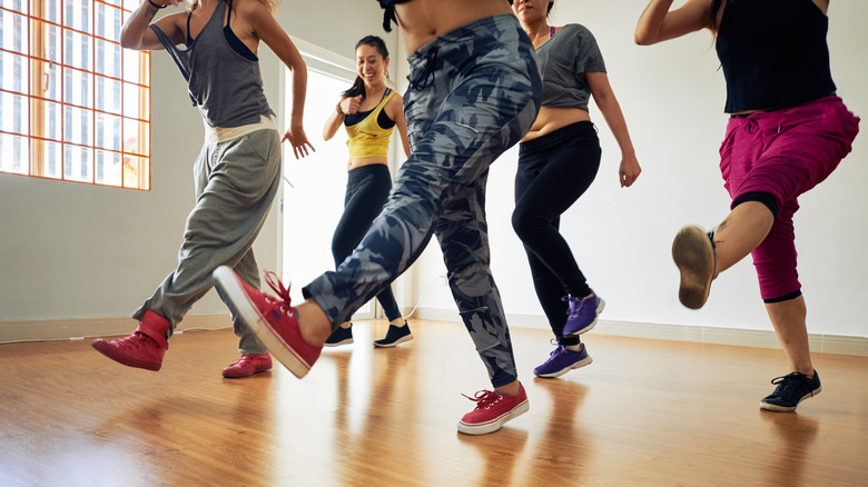 Group of people doing leg swings