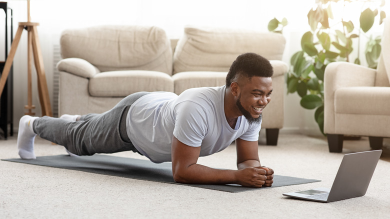Man doing planks at home