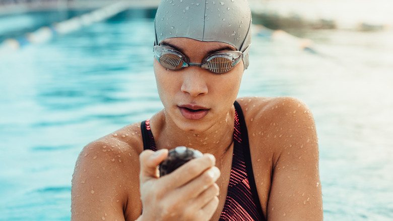 Woman in swim cap and goggles