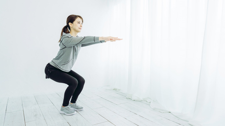 woman doing half squats