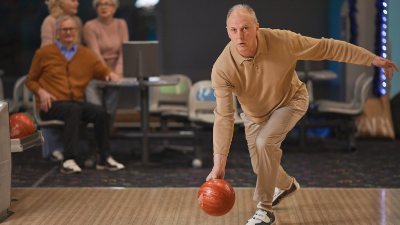 Male holding bowling ball 