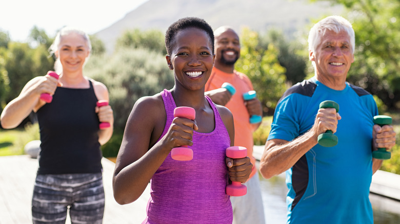 group of mature men and women with free weights