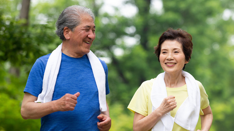 man and woman walking or jogging outside