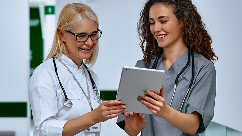 Doctors looking at a tablet