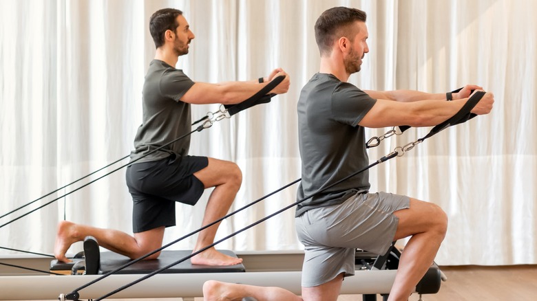 Man doing pilates in gym