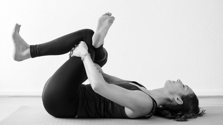 woman in reclining pigeon pose